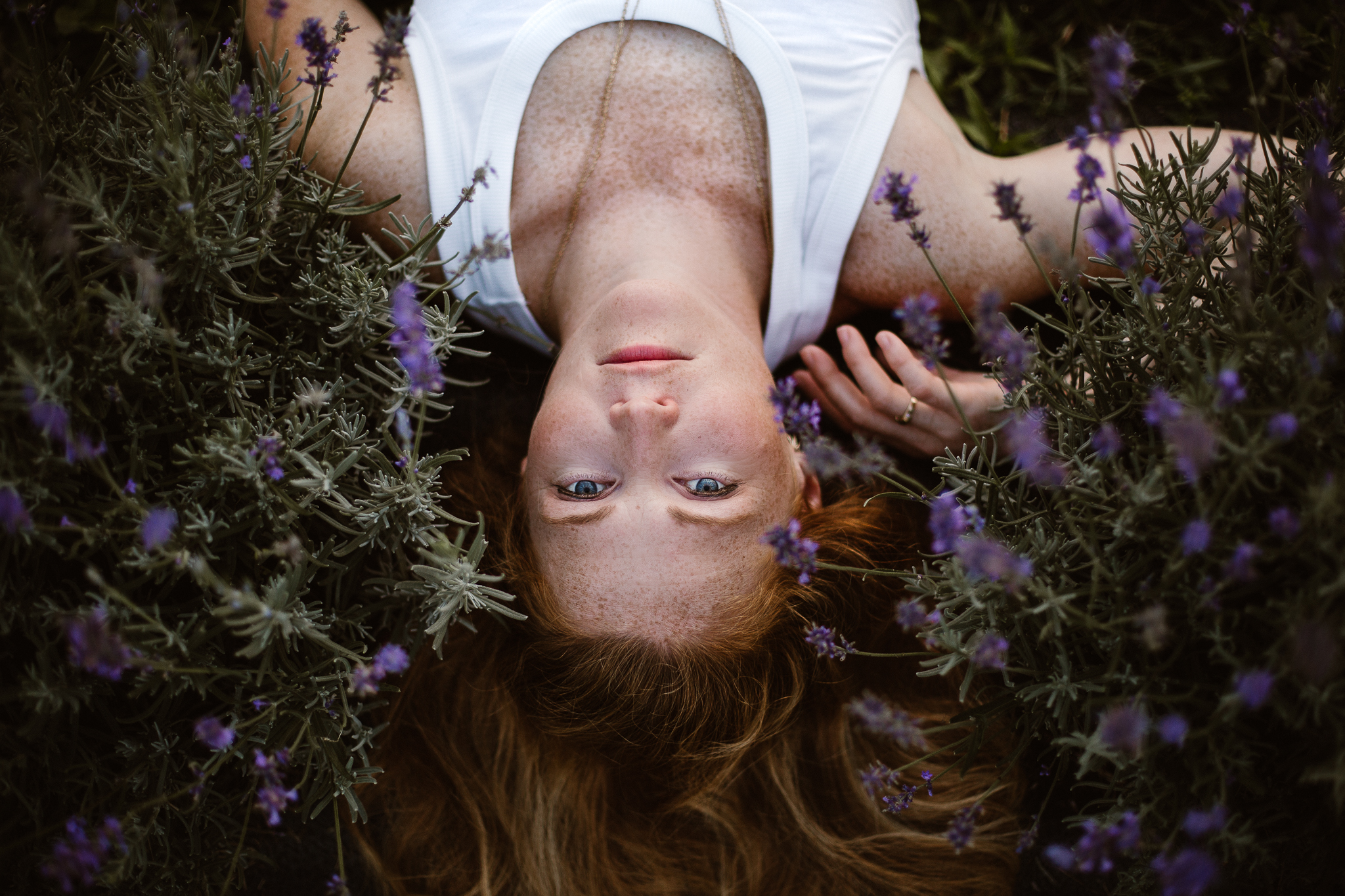 Red headed woman in yellow skirt at sunset in a lavender field.